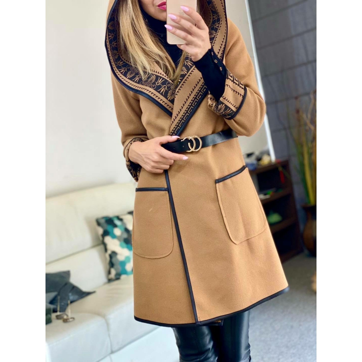 a woman holding a cell phone in her hand