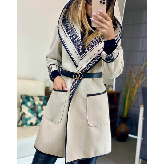a woman in a white coat is talking on a cell phone 